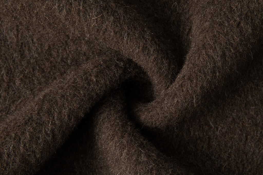 Close-up of the dark brown fabric showing its fine raised fibres.