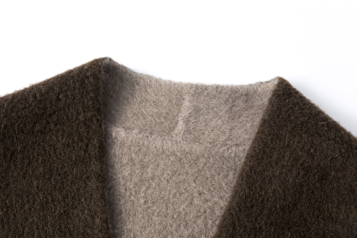 Close-up of the collarless neckline and contrasting lighter inner face.