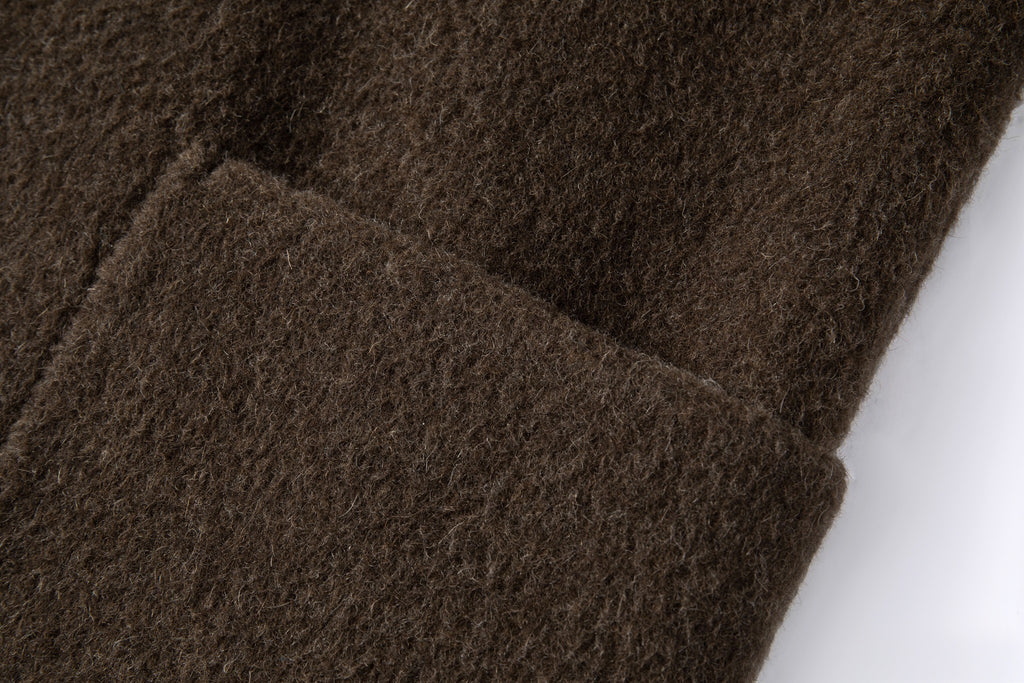 Close-up of the rectangular front patch pocket and brushed wool and yak-blend surface.