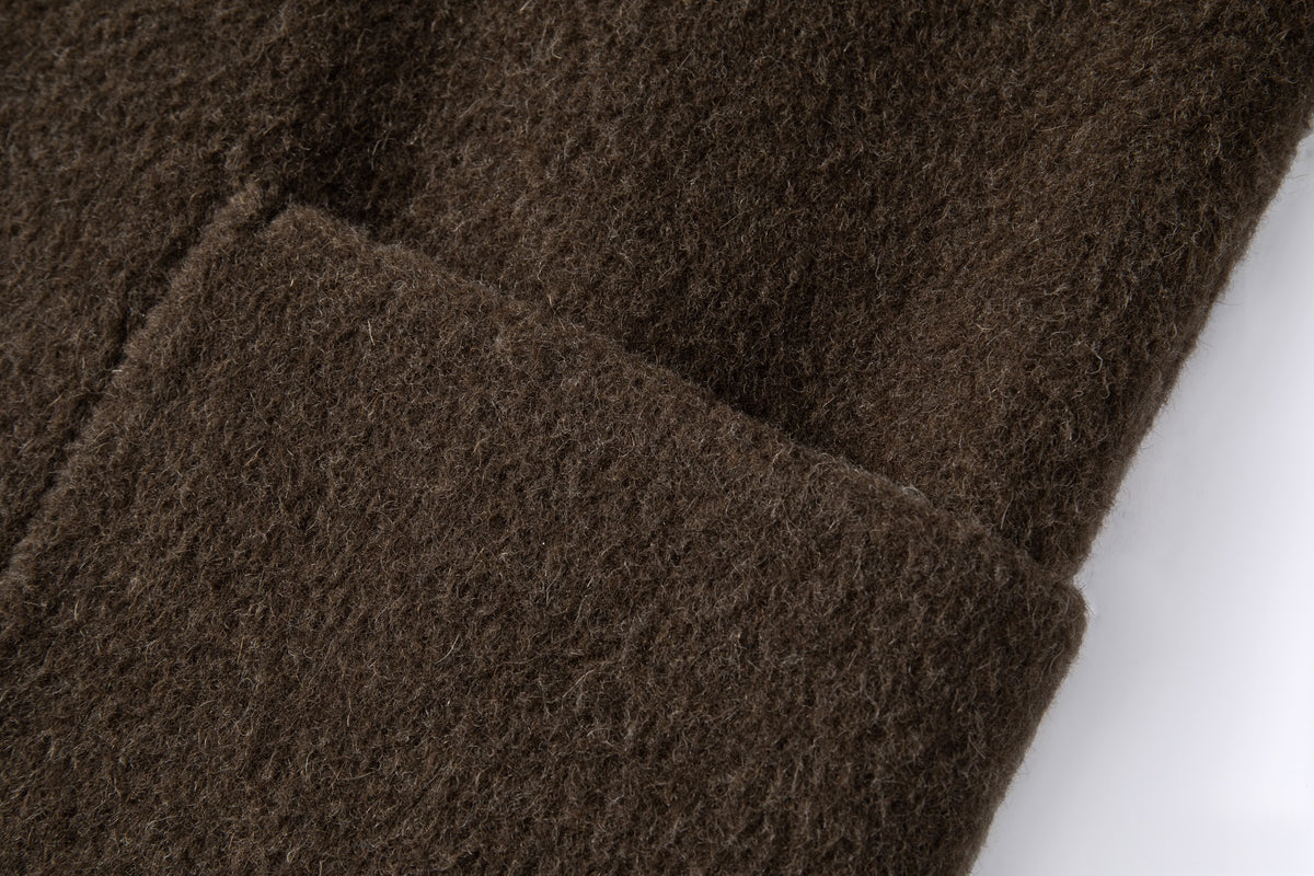 Close-up of the rectangular front patch pocket and brushed wool and yak-blend surface.