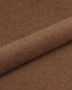 Coffee wool fabric detail with a diagonal fold; colour-adjusted image.