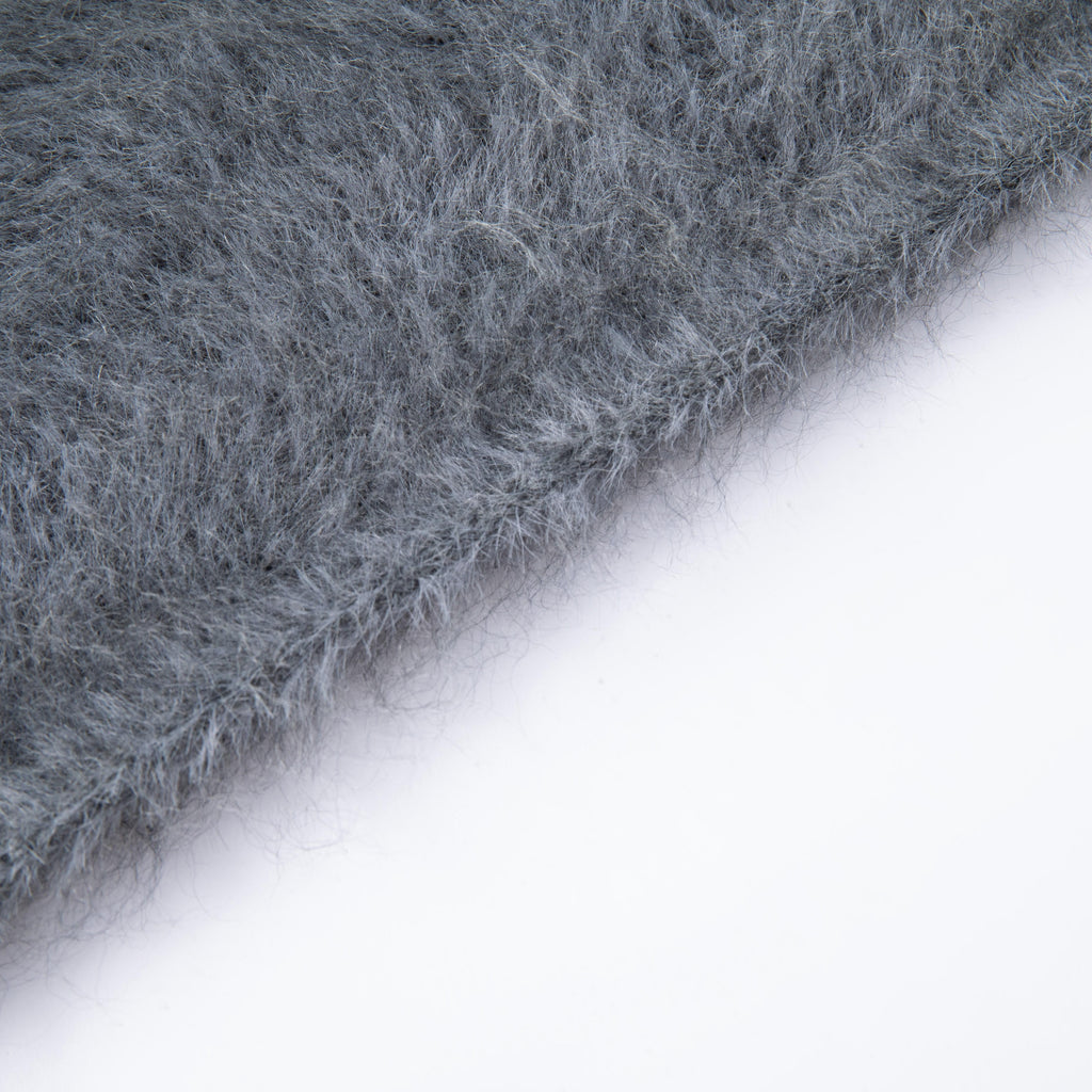 Close-up of the finished knitted edge and fine fibres of the Grey hooded scarf.