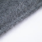 Close-up of the finished knitted edge and fine fibres of the Grey hooded scarf.