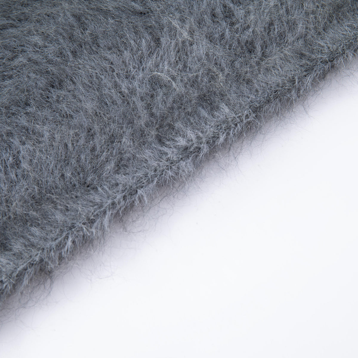 Close-up of the finished knitted edge and fine fibres of the Grey hooded scarf.