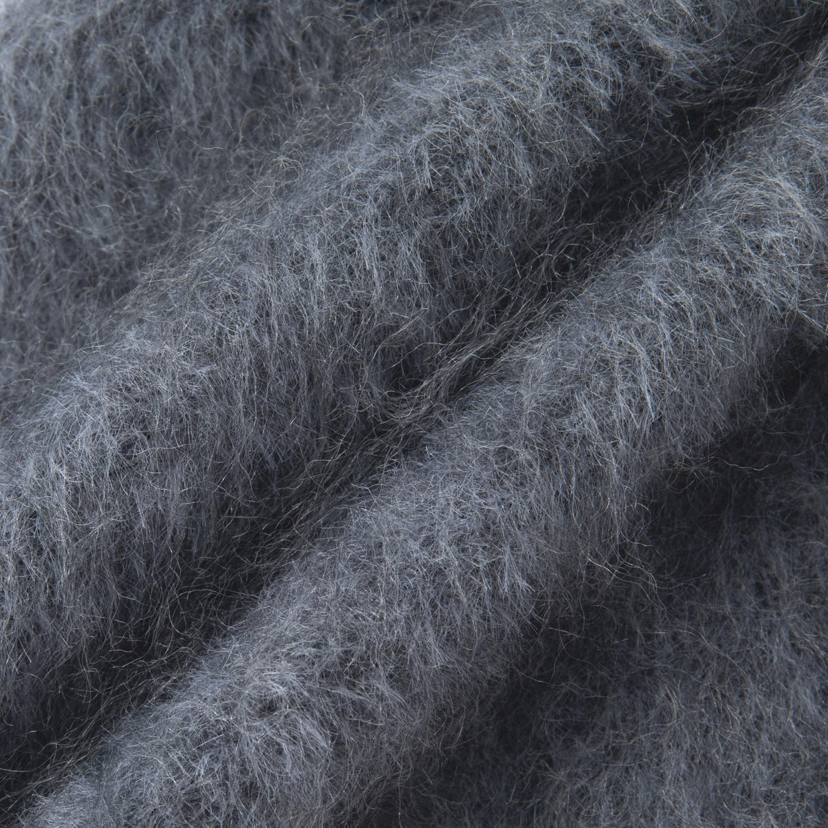 Close-up of the Grey hooded scarf's fuzzy knitted texture and fine fibres.
