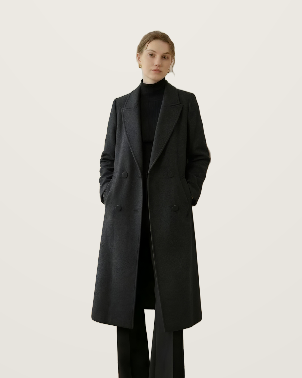 Black double-breasted wool coat worn with a black roll-neck and trousers.