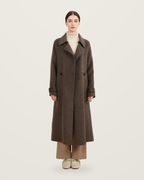 Coffee-coloured coat with cuff tabs, worn with a cream roll-neck and taupe trousers.