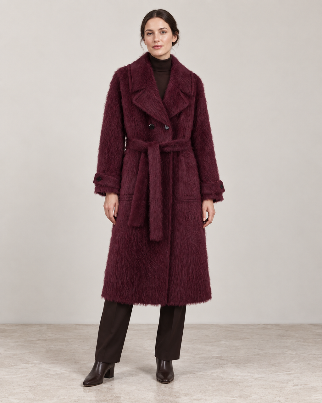 The Kensington plush coat in Plum, showing the notched lapels, self-fabric belt and cuff tabs.