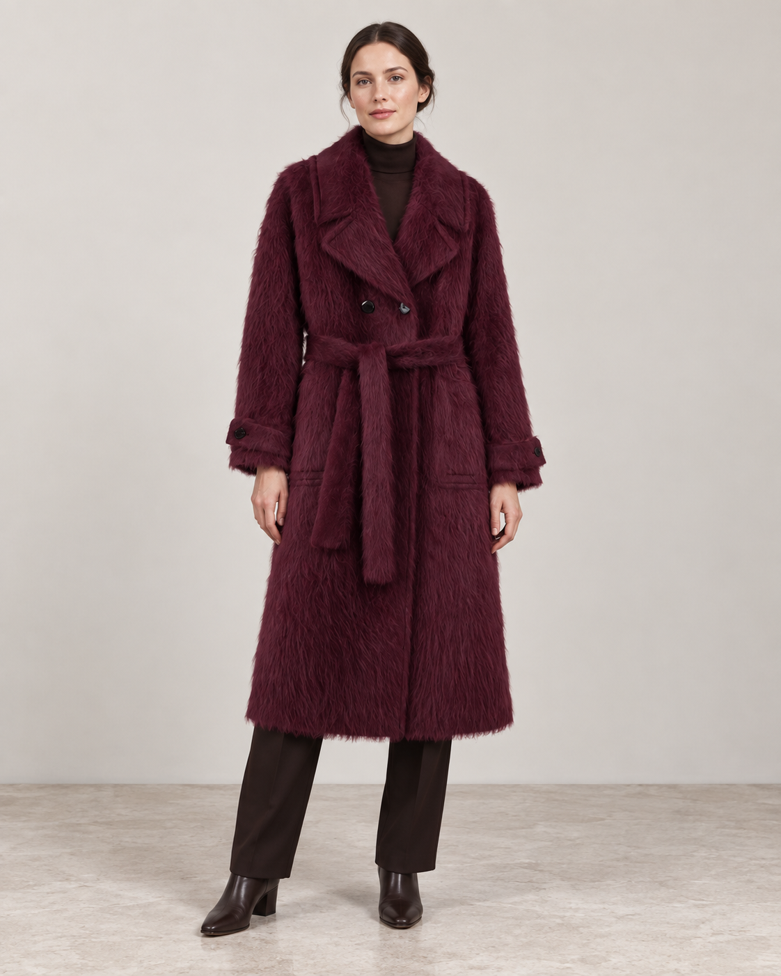 The Kensington plush coat in Plum, showing the notched lapels, self-fabric belt and cuff tabs.