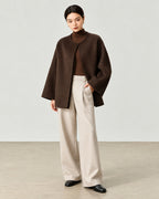 AI-assisted styling of THE LANE 007 Coffee pure wool oversized short coat, round neckline, dropped shoulders, wide sleeves and no patch pockets. Full-length styling view.