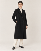 THE LANE 066 Black coat with curved lapels, full-length styling view, with three visible front buttons