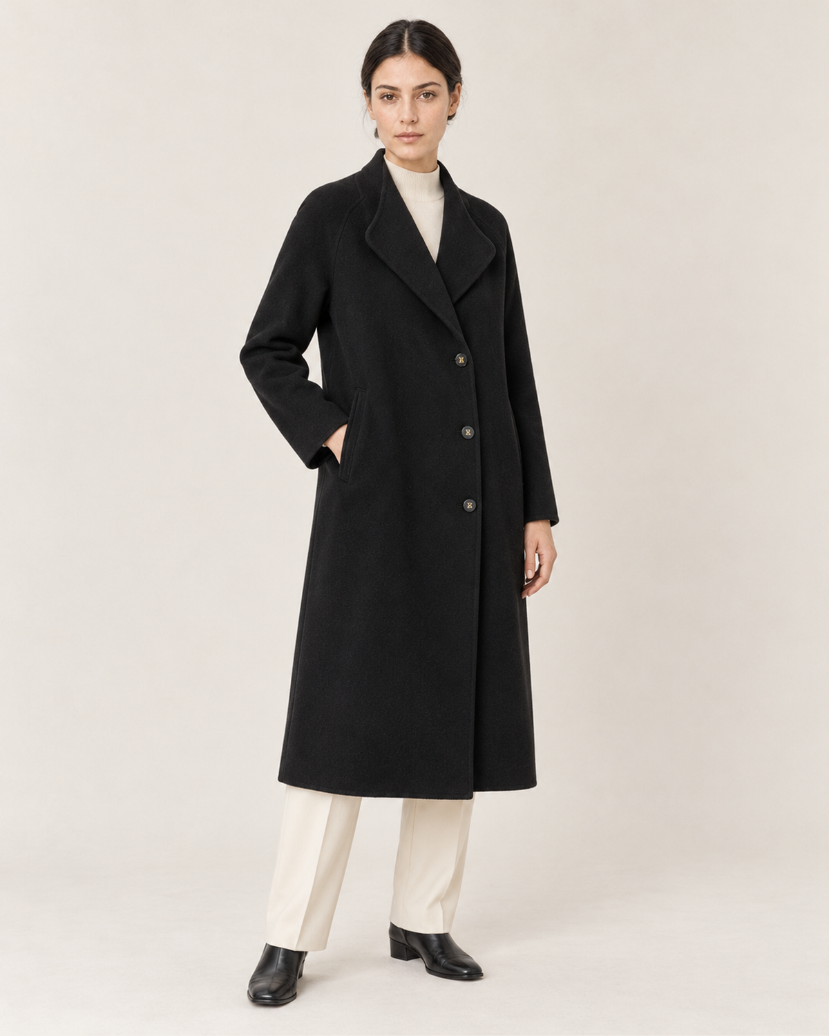 THE LANE 066 Black coat with curved lapels, full-length styling view, with three visible front buttons