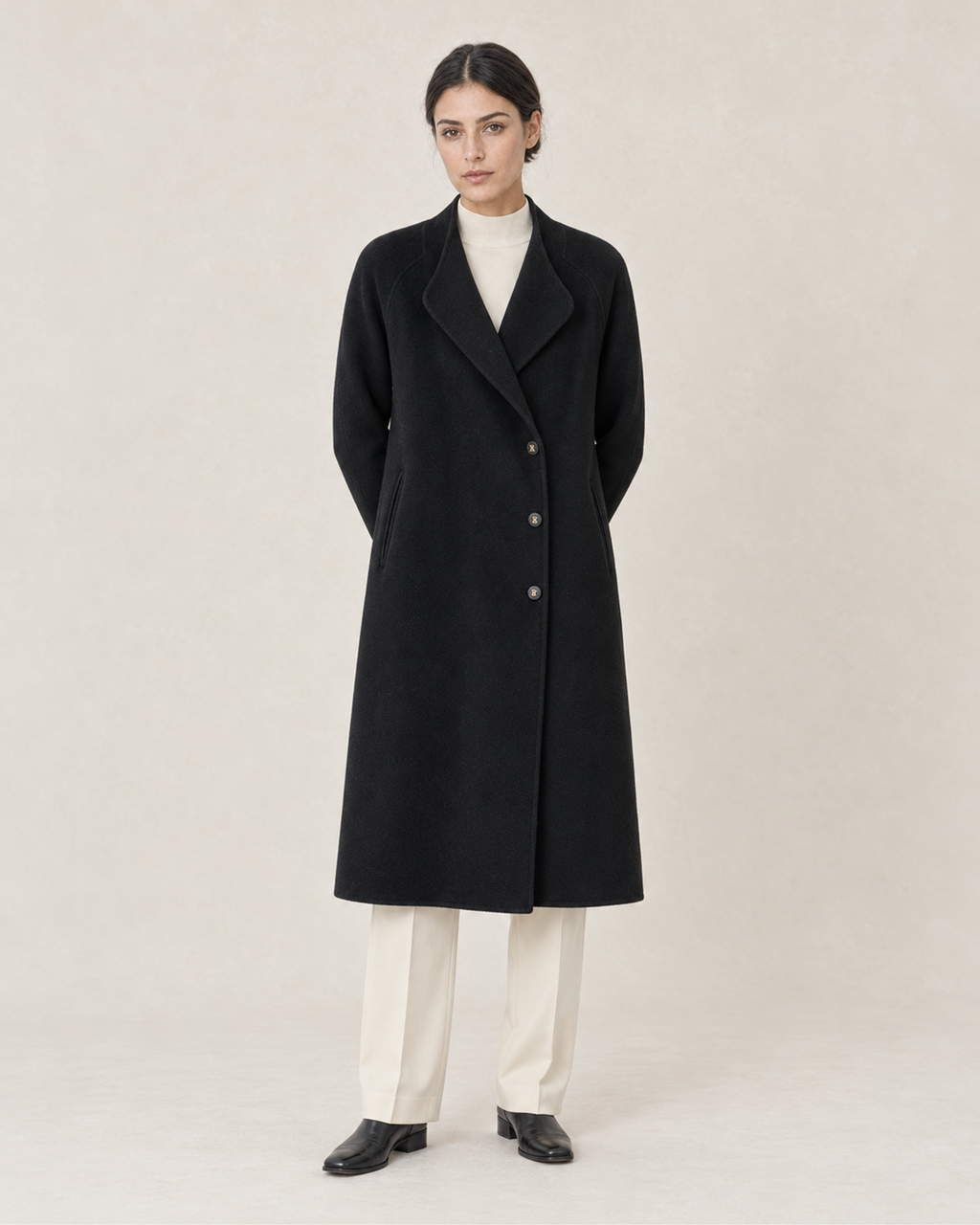 THE LANE 066 Black coat with curved lapels, front styling view, with three visible front buttons