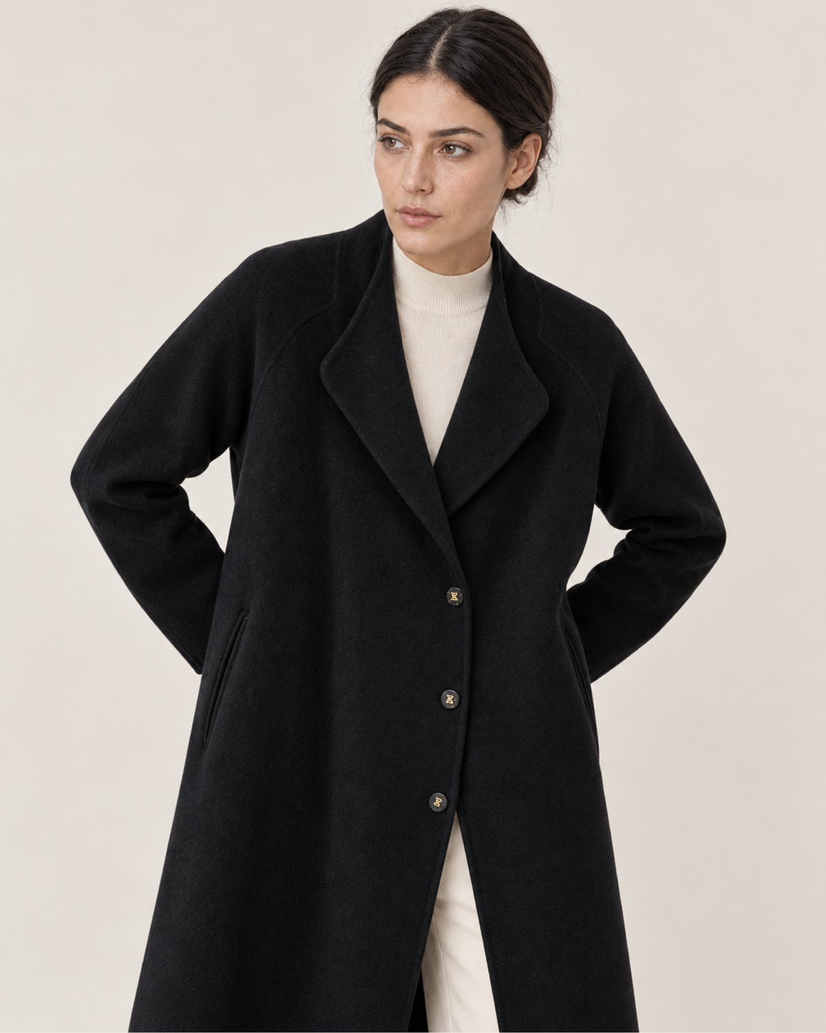 THE LANE 066 Black coat with curved lapels, upper-body styling view, with three visible front buttons