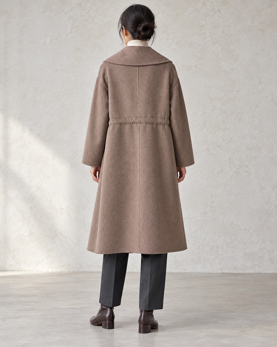 Vienna coat in Brown, relaxed rear model view with centre back seam and integral drawcord channel — AI-assisted styling image.