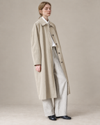 Cream Richmond cotton-Tencel trench coat, AI-assisted adaptation of the original model photograph to a warm neutral studio.