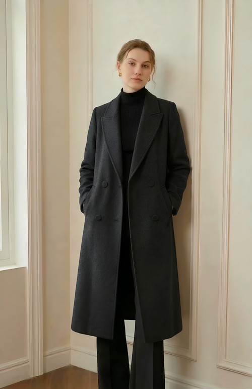 Black Belgravia double-breasted wool maxi coat worn with a black rollneck and trousers in the original supplied model photograph.
