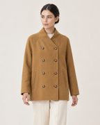 AI-assisted upper-body styling crop of THE LANE 25219 Brown straight-cut coat, with all eight existing buttons fastened.