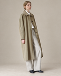 Coffee Green Richmond trench coat, studio background adapted from the original model photograph.
