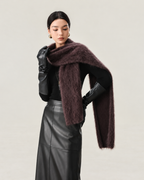 Purple cashmere and wool-blend scarf worn with both ends draped at the front, in a portrait studio composition.
