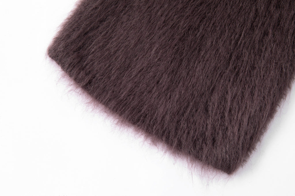 Close-up of the purple scarf showing its brushed surface and finished edge