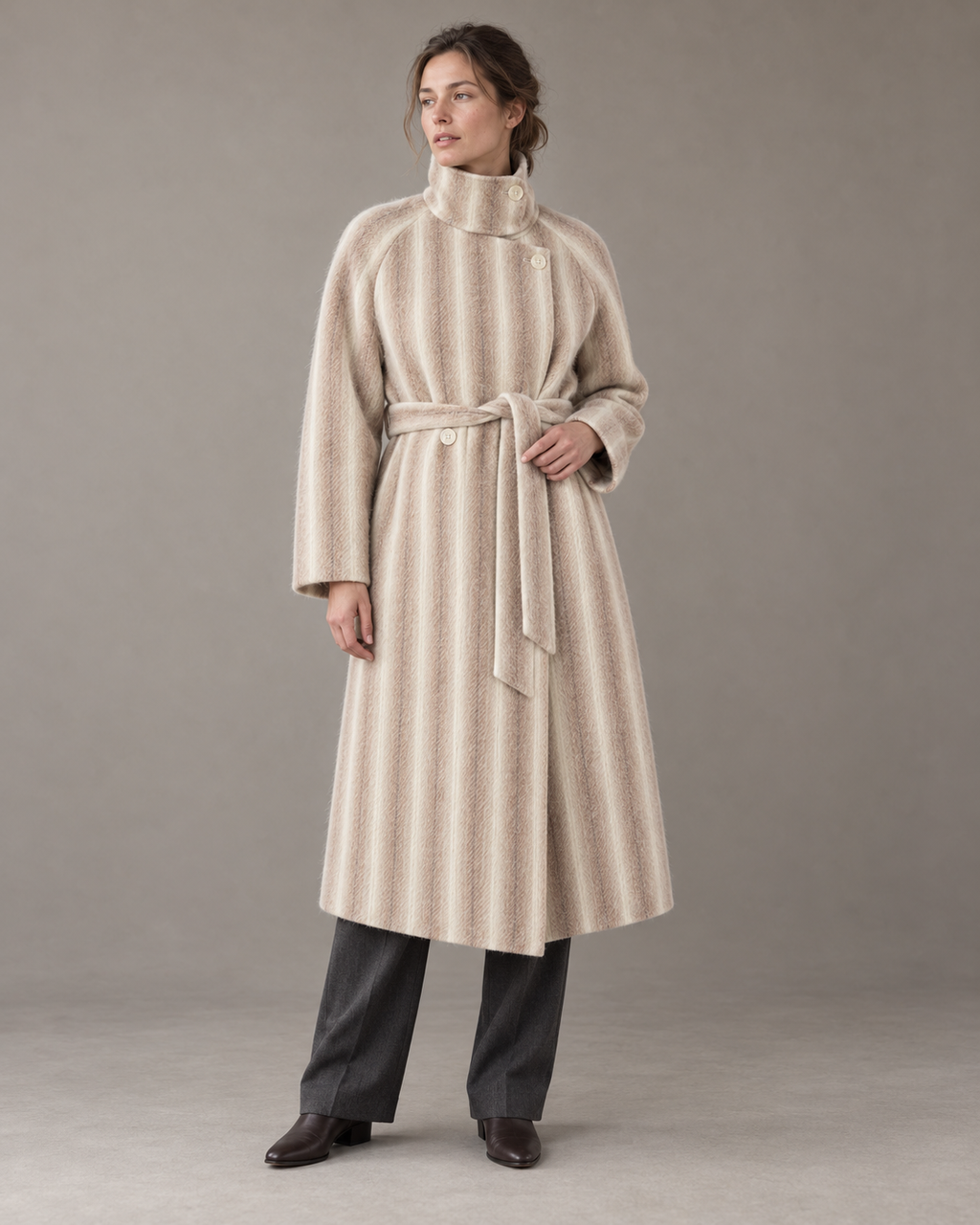 Striped Brown Heritage coat with the collar fastened upright and matching belt, styled with charcoal trousers and dark leather boots. AI-assisted styling based on supplied garment and fabric photographs.