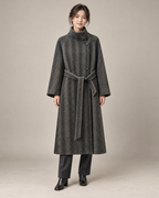 Striped Grey Heritage overcoat with the wraparound collar fastened upright and matching self-tie belt, styled with charcoal trousers and black ankle boots. AI-assisted studio styling.